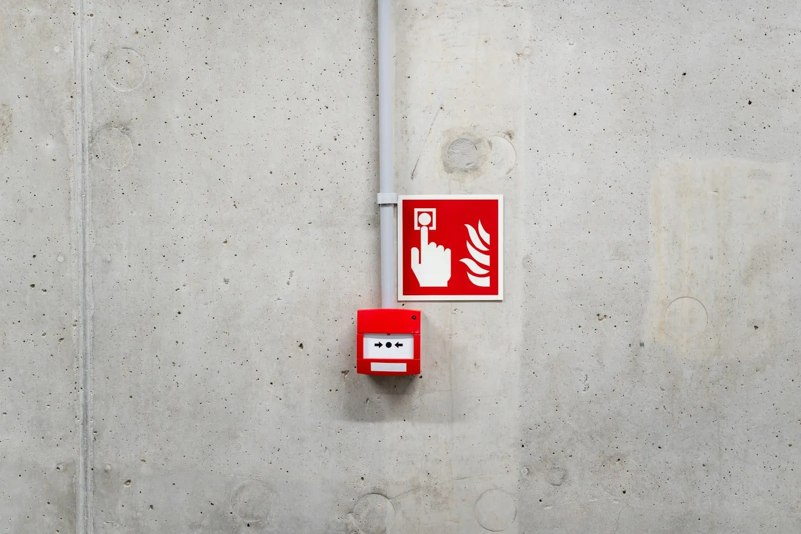 A red fire alarm call point on a wall