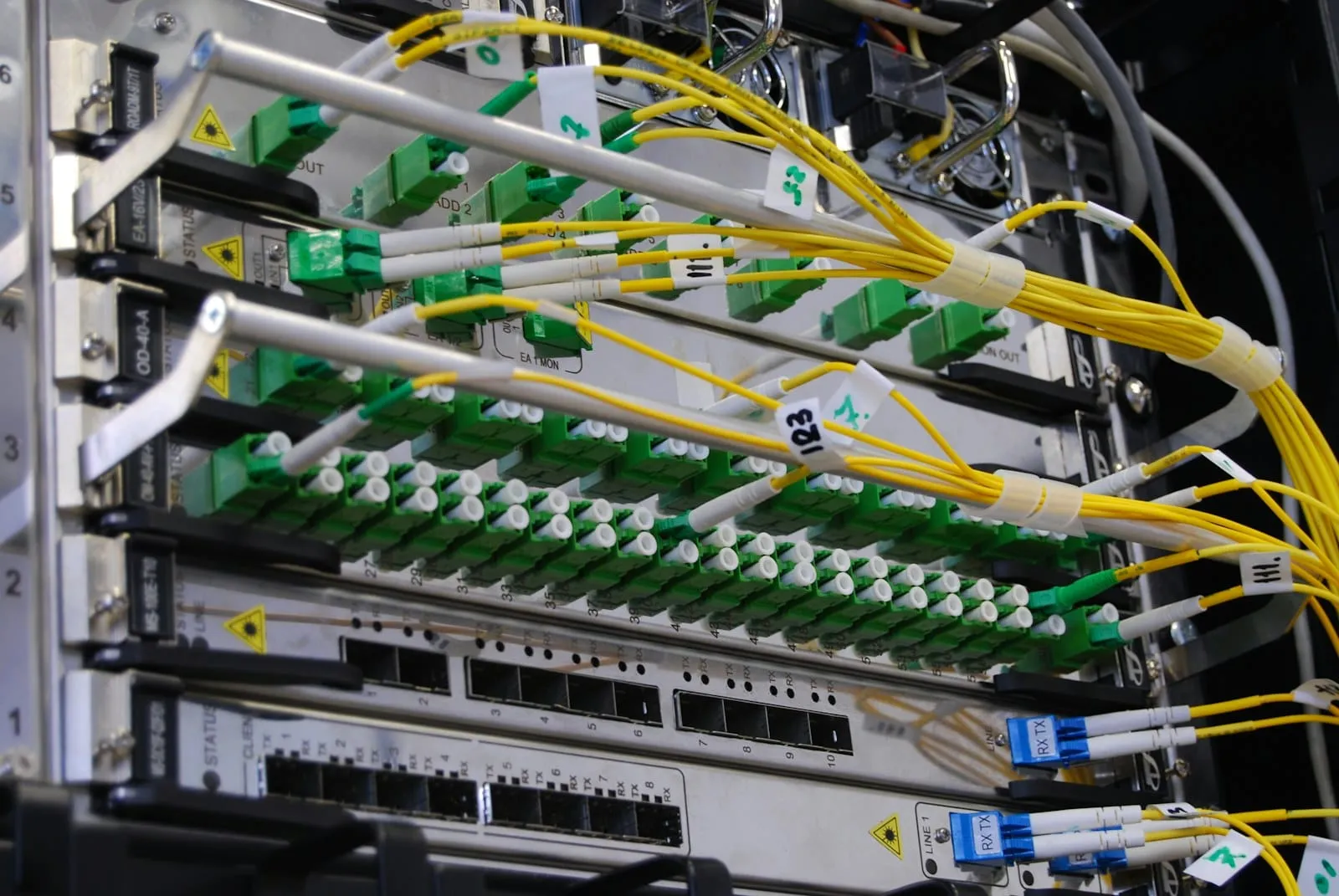 Fibre and network cables connected to a switch in a rack